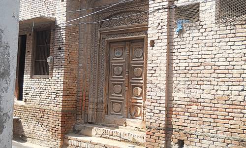Description: Carved wooden entrance of a relative’s house