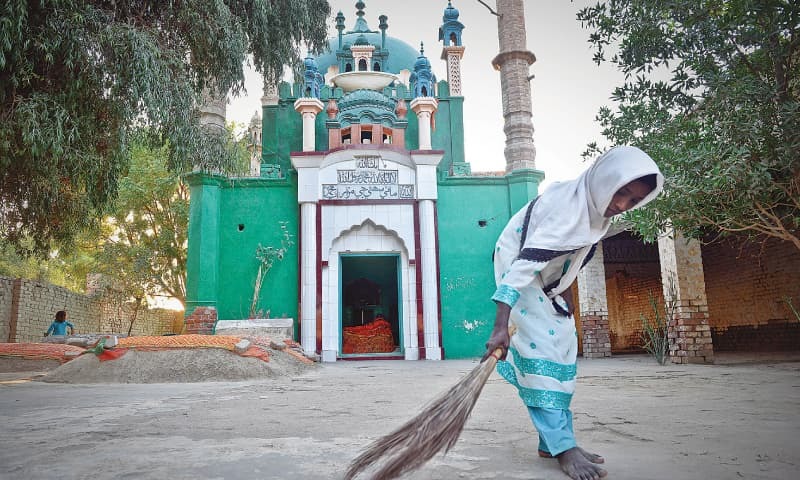 Description: A WOMAN sweeps the floor of the 400-year-old mausoleum of Sohni in Shahdadpur, Sindh.—Fahim Siddiqi / White Star