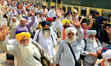 Description: Sikh pilgrims proclaim their arrival with a hearty gesture at the Wagah Railway Station. — White Star