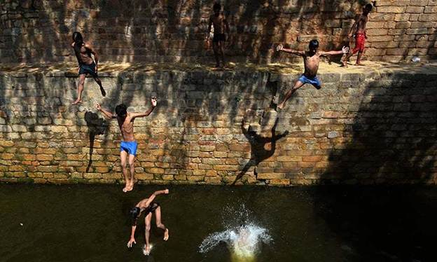 Description: In this representative photo, an Indian youth jumps into the water at the Gandak ki Baoli, 'a well with steps' which was constructed during the rule of Emperor Iltutmish, in New Delhi. — AFP/File