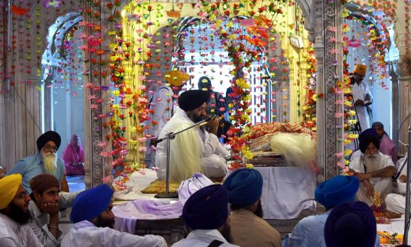Description: Sikh pilgrims attend a prayer session inside the compound of Maharaja Ranjit Singh's mausoleum. -AFP