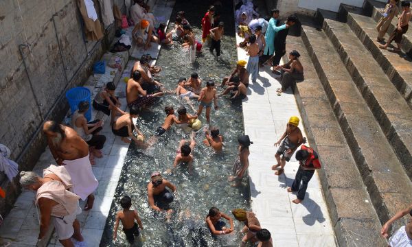 Description: Sikh pilgrims bathing in the holy water at Punja Sahib.