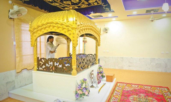 Description: A worshipper reverently fans the Guru Granth Sahib with a fly whisk  in Gurdwara Shah which opened to the public in Bhit Shah on Sept 4. —Fahim Siddiqi / White Star