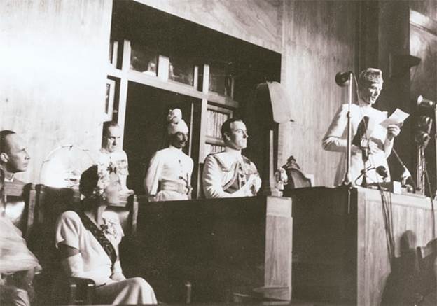 Description: Quaid-i-Azam delivers a speech on August 14, 1947, in Karachi as Lord Mountbatten looks on.
