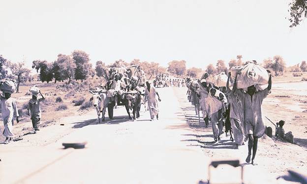 Description: On foot or on bullock carts, the people migrated to the new land.