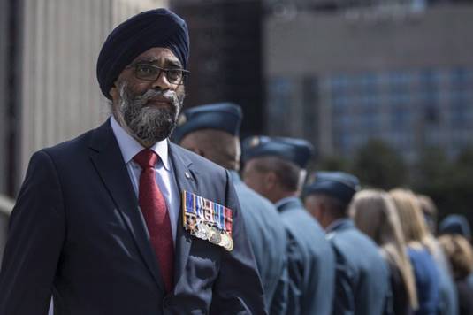 Description: Defence Minister Harjit Sajjan displays his service medals as he leaves a Royal Canadian Air Force ceremony on Sept. 1, 2017.