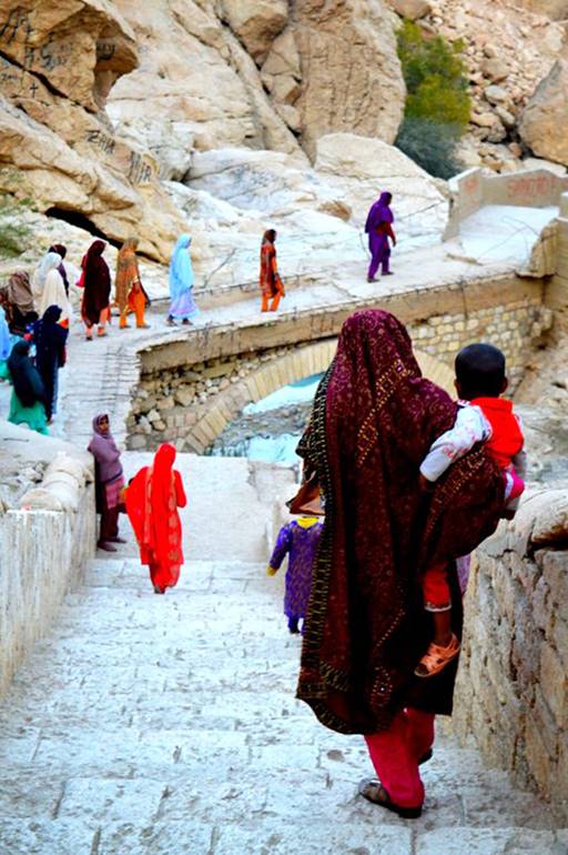 Description: Balochi women returning from the cave.