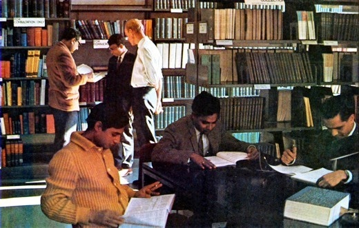 Description: Abdus Salam with his peers at the ICTP library. —  ICTP Photo Library