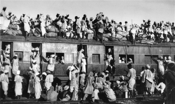 Description: Muslim refugees sit on the roof of an overcrowded train near New Delhi as they try to flee India on Sept. 19, 1947. In the partition of the subcontinent into India and Pakistan after gaining independence from Britain in 1947, an estimated 1 million Hindus, Muslims and Sikhs were killed in rioting, and 12 million were uprooted from their homes.
