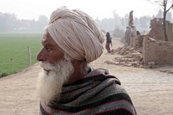 Mal Singh as father in front of the house that was constructed and demolished for the shoot-.jpg
