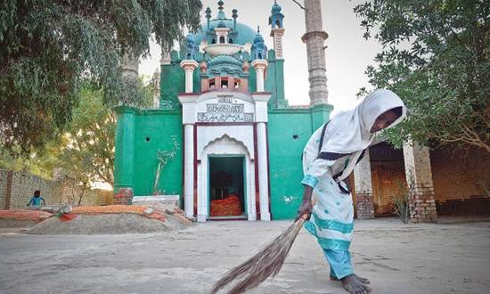 Description: Description: A WOMAN sweeps the floor of the 400-year-old mausoleum of Sohni in Shahdadpur, Sindh.—Fahim Siddiqi / White Star