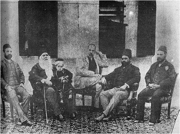 Description: Sir Syed enjoys an evening at his home with a group of Muslim intellectuals. The child on his lap is his grandson.