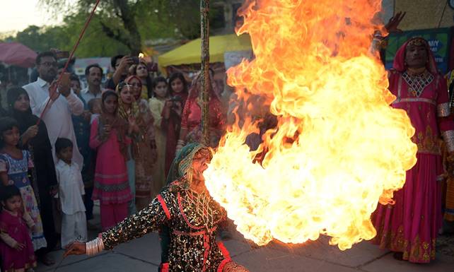 Description: A Pakistani folk artist from Cholistan breathes fire as she performs during the annual Lok Mela festival ─ AFP