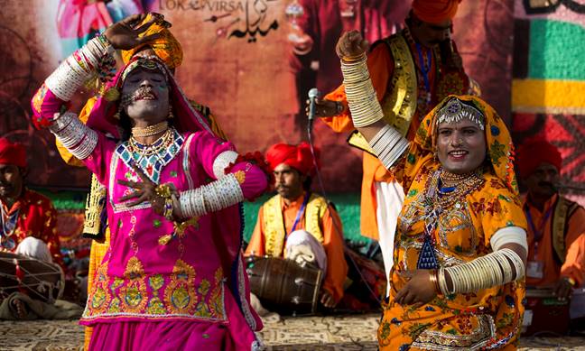 Description: Folk artists, who are eunuchs and street performers belonging to the minority Hindu Bheel community, perform at the festival. ─ AP