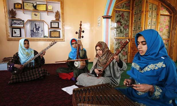 Description: Kashmiri Muslim girls play instruments and sing Sufi music under the tutelage of music teacher, Muhammad Yaqoob Sheikh, on the outskirts of Srinagar. —AFP