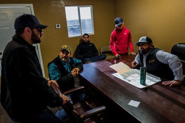 Description: Simon Sihota, right, holds a meeting at his company’s field office in Selma. He and his sons work together, managing and operating nearly 2,500 acres of farmland in Selma, Calif., and the South Valley.